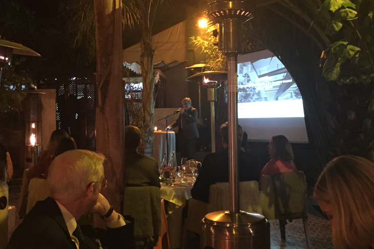 Guests watch presentations at the EP100 Unlocking Energy Productivity dinner.